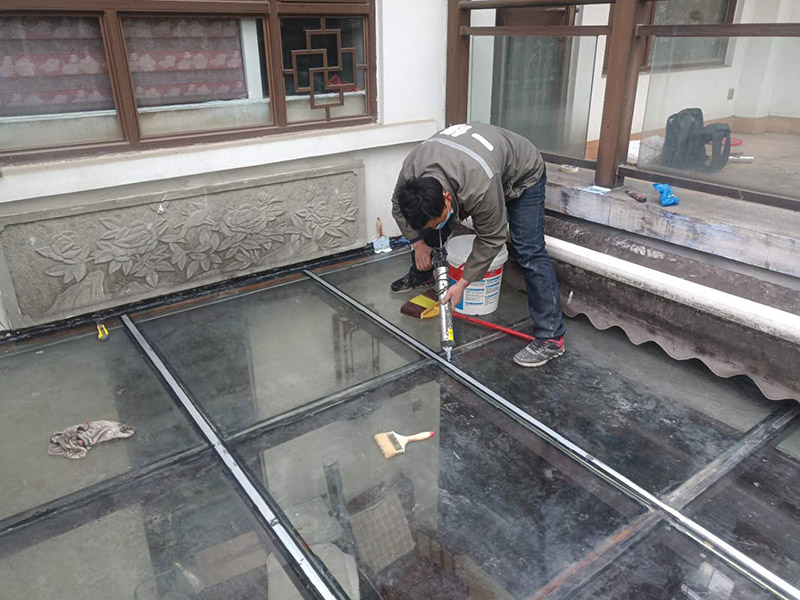 玻璃屋頂打膠防水：把陽光房的邊清理干凈。用結(jié)構(gòu)膠往縫里填到60%。然后用和縫大小的泡抹棒往里壓填充，把膠往陽光房與型材的縫里擠。最后填充耐候密封膠，用刮刀來回30度角度刮2遍。缺膠的補(bǔ)上。30分內(nèi)把紙揭掉。陽光房的鋁合金、鋼材等框架材料連接處基本靠打建筑膠來固定與防漏水。建筑膠打膠前，需要將打膠處用溫布擦干凈且干了之后打膠，否則就算是用了高級的建筑膠，其實(shí)際效果只有普通建筑膠的效果，將會大大降低陽光房結(jié)構(gòu)膠的使用壽命。